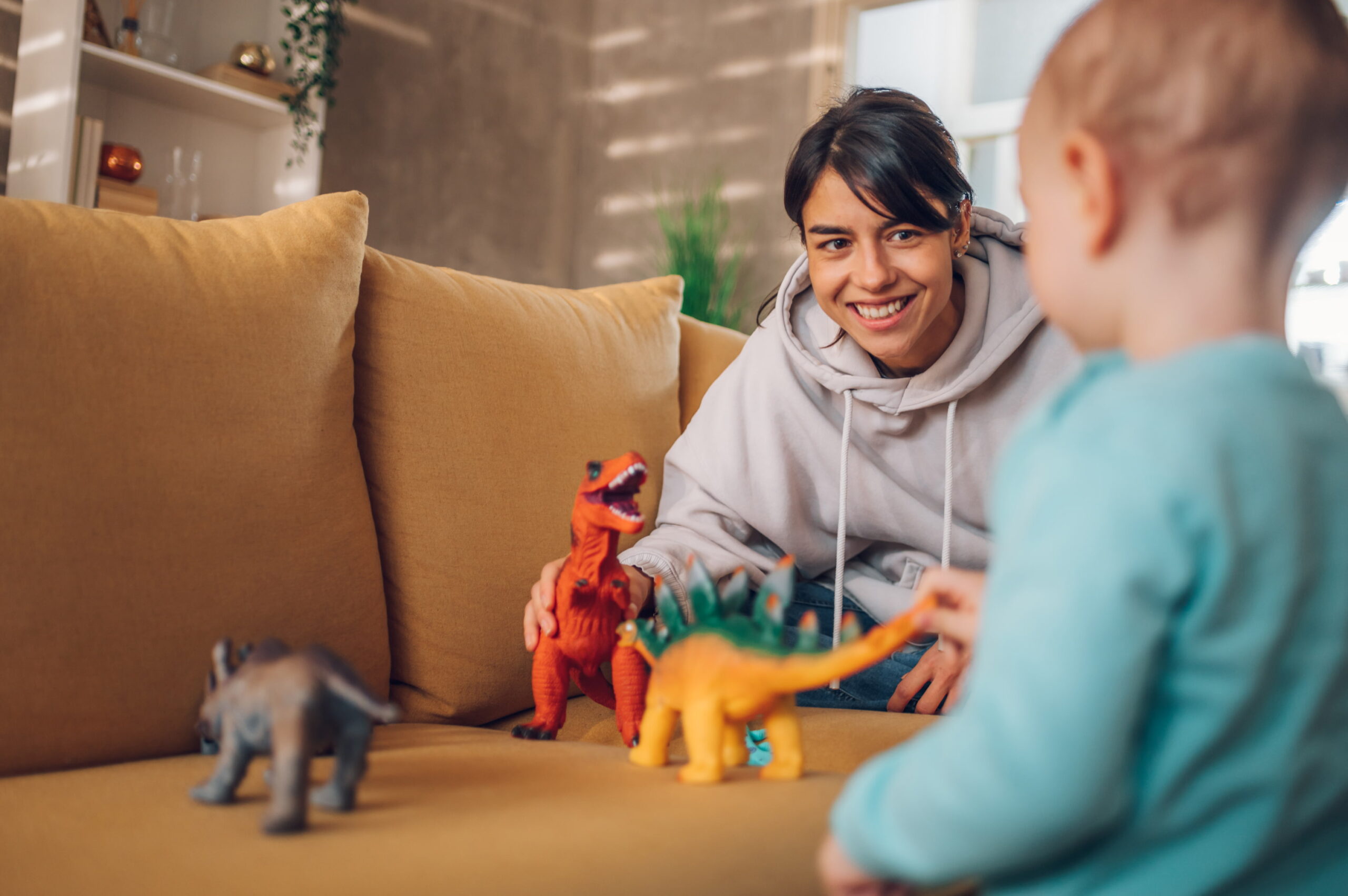mother-and-toddler-son-playing-with-dinosaurs-toys-2024-03-08-17-19-38-utc